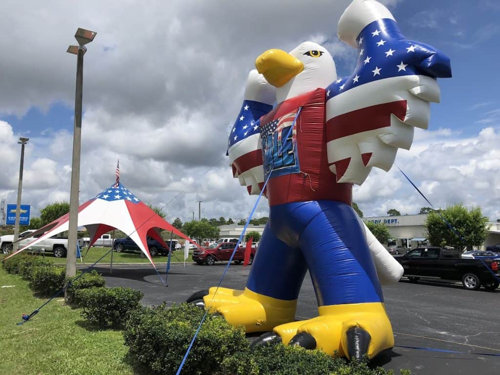 Red, white, and blue holiday advertising inflatables for rent in Florida.